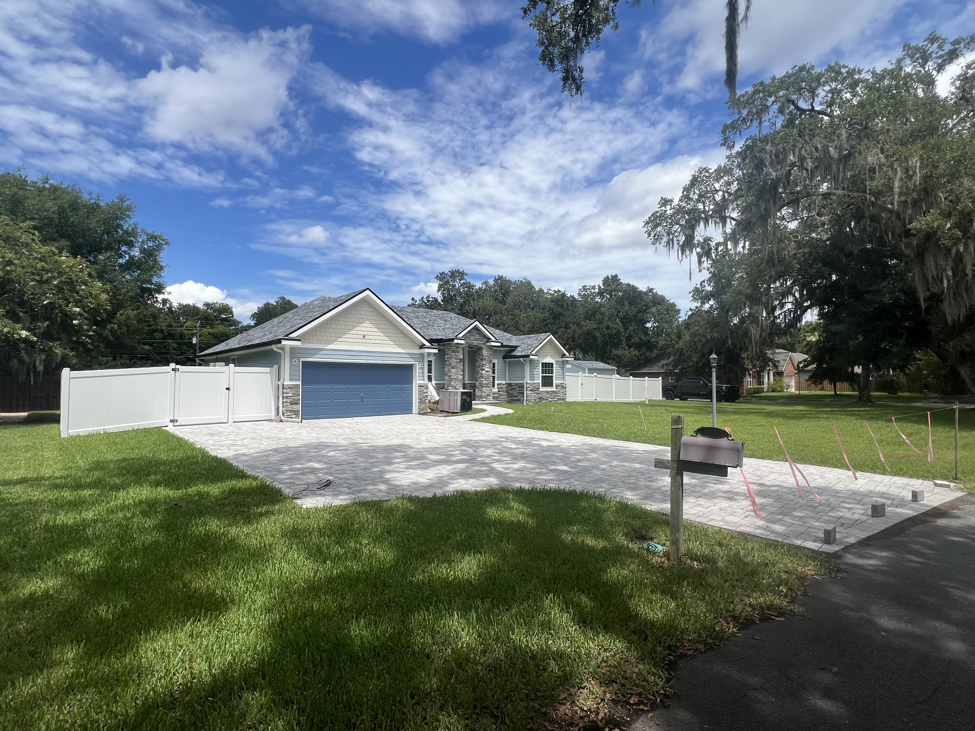 Custom home with paver driveway